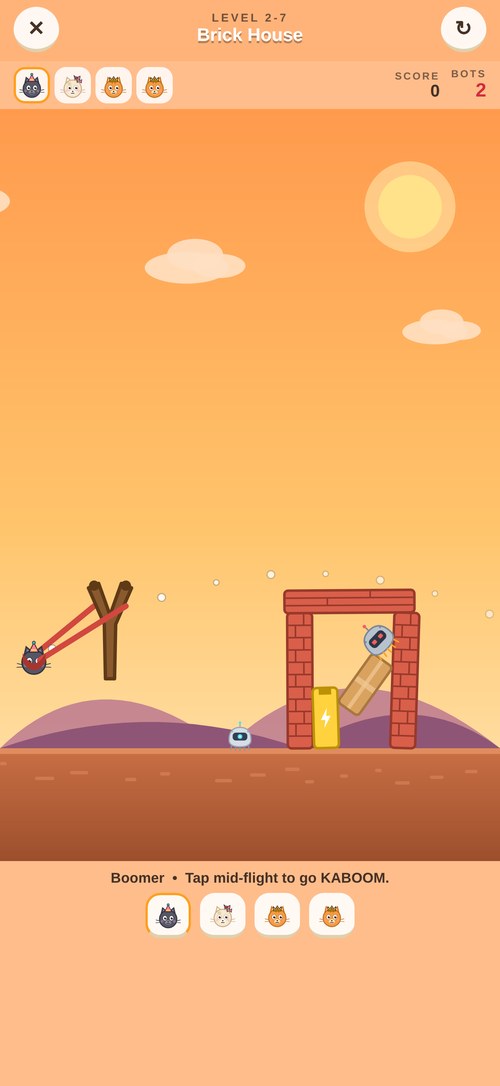 Kitty Kaboom gameplay — aiming the slingshot at a robot tower